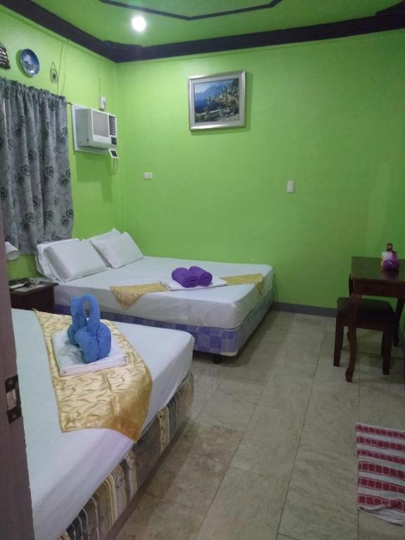 Postel nebo postele na pokoji v ubytování Sascha's Resort Oslob