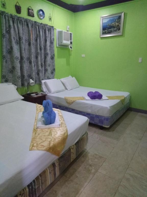 Postel nebo postele na pokoji v ubytování Sascha's Resort Oslob