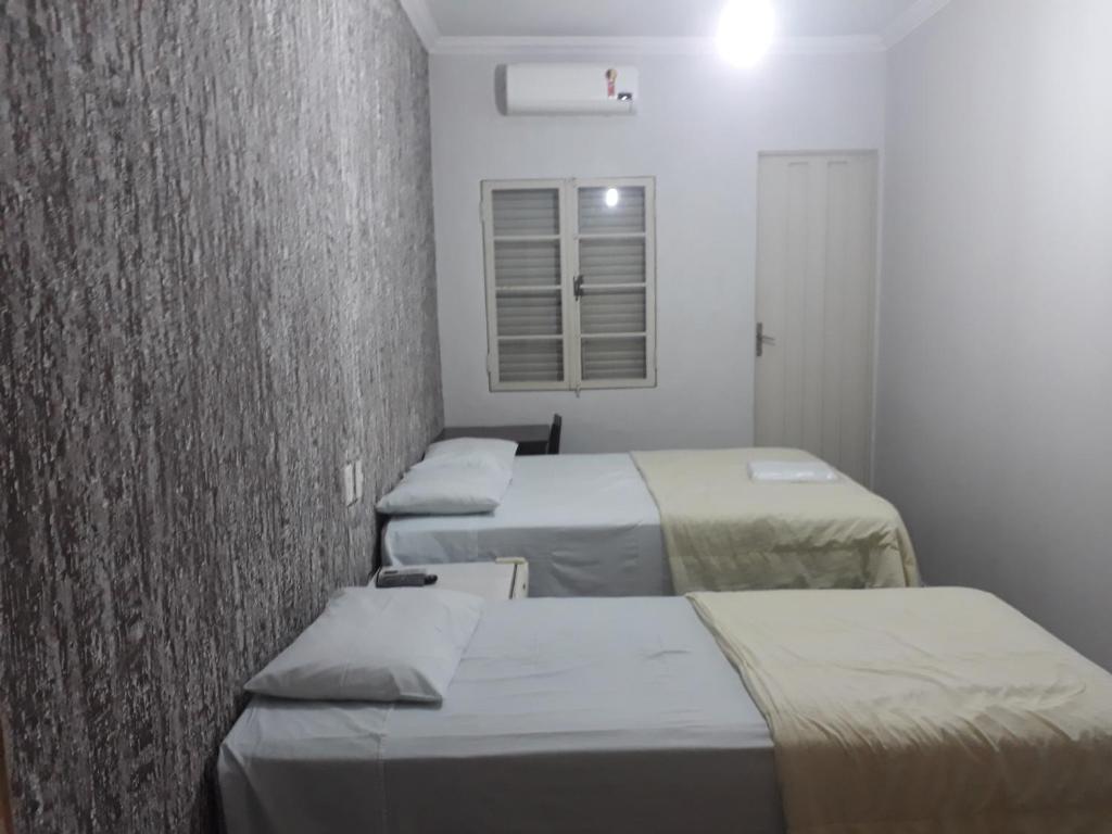 a row of beds in a hospital room at Araca Hotel in Araçatuba