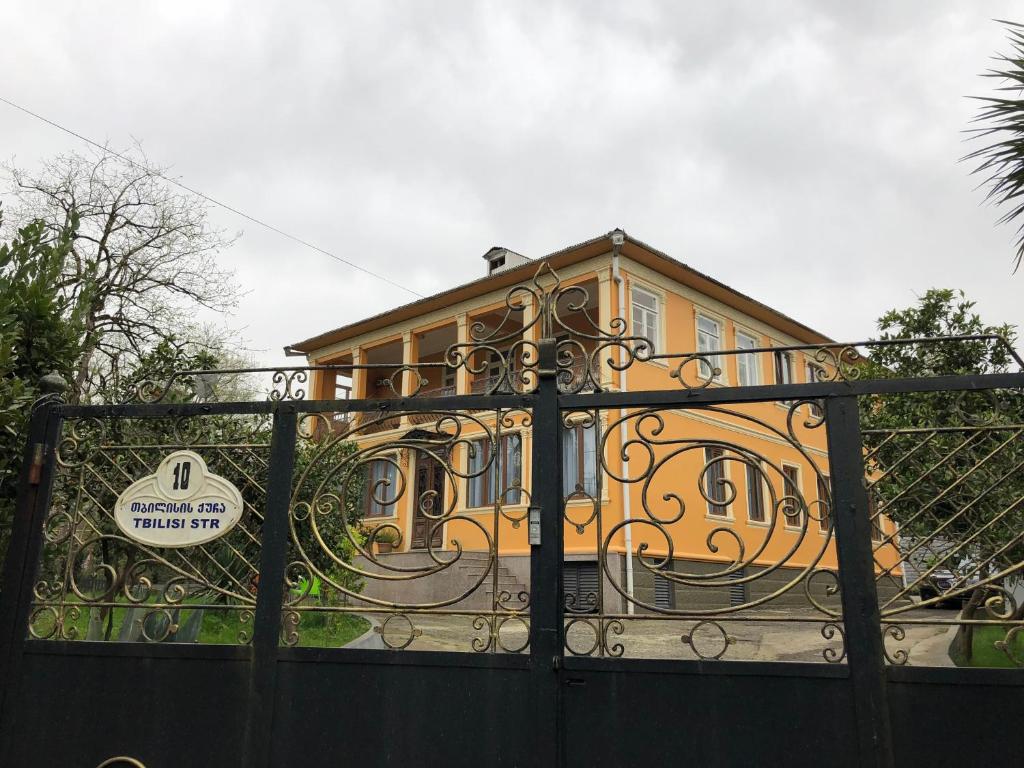a house behind a gate with a building at TEMO GUEST HOUSE 10 in Batumi