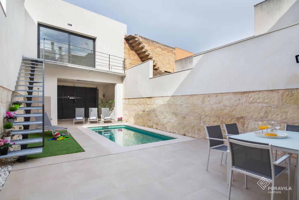 a swimming pool in the backyard of a house at Ca Na Foc in Sa Pobla