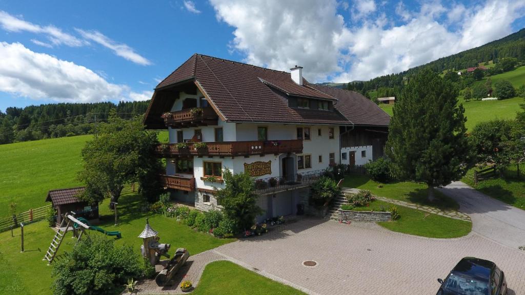 an aerial view of a house in a green field at Pfeifferhof in Mariapfarr