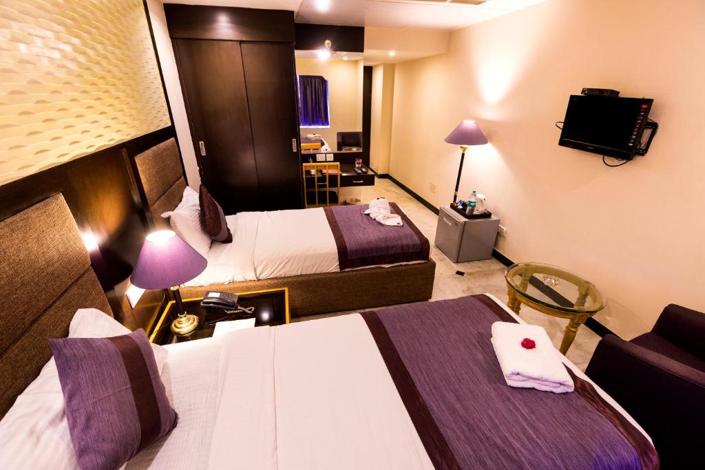 Postel nebo postele na pokoji v ubytování Hotel Grand Residence