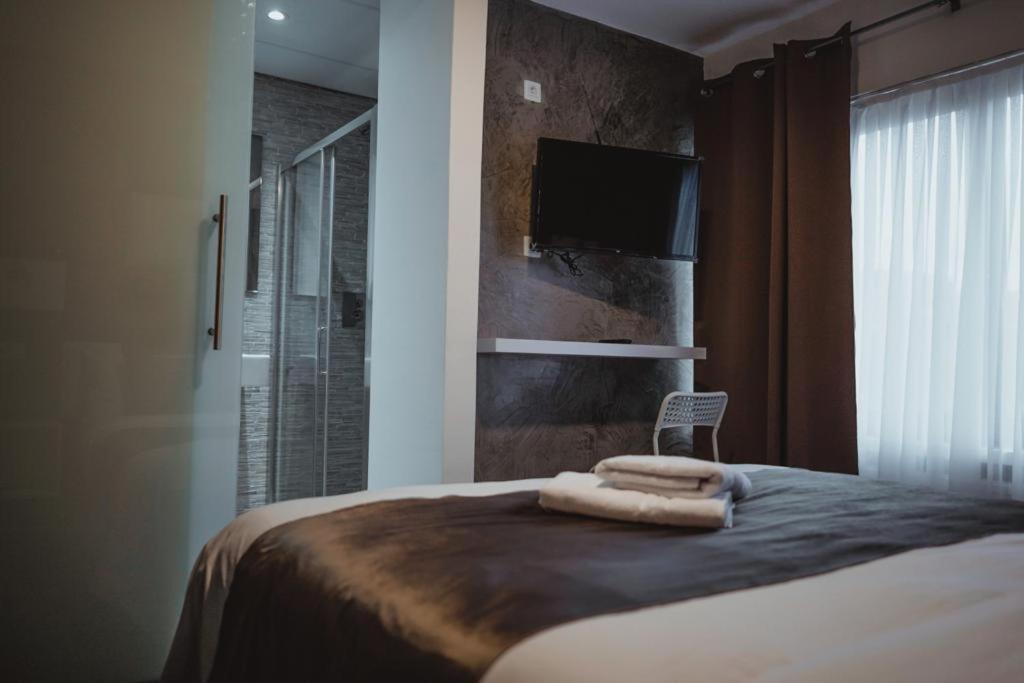 Postel nebo postele na pokoji v ubytování Hôtel onyx expo
