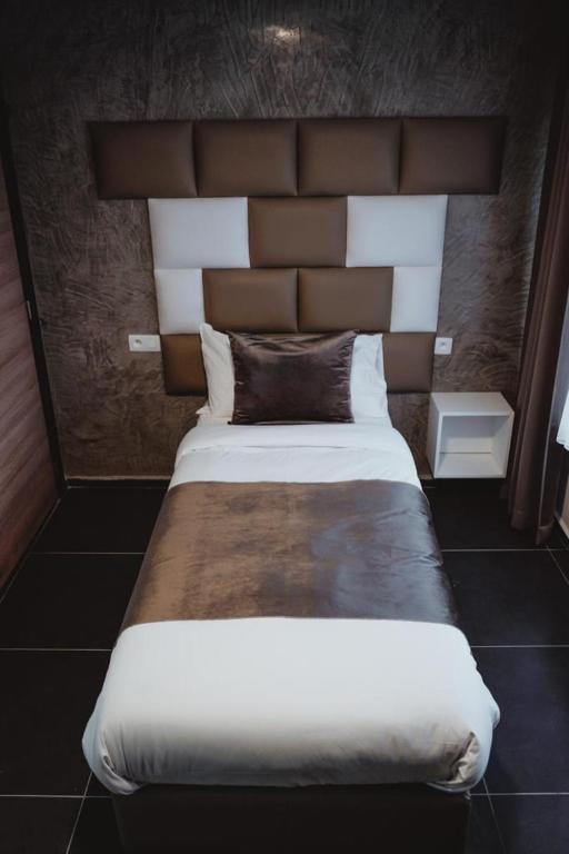 Postel nebo postele na pokoji v ubytování Hôtel onyx expo