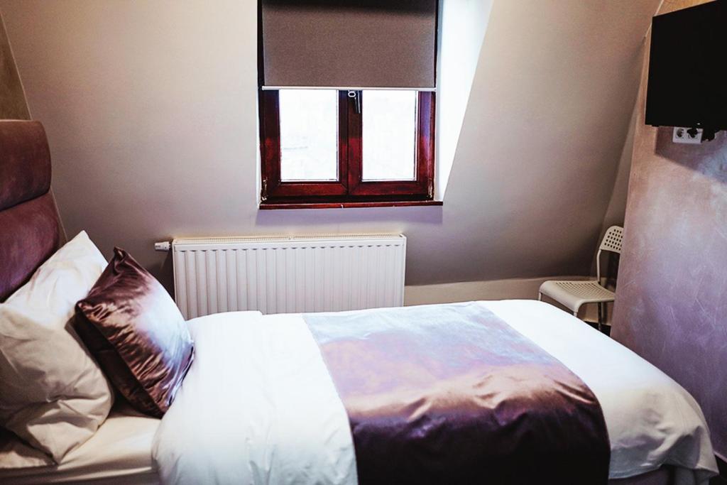 Postel nebo postele na pokoji v ubytování Hôtel onyx expo