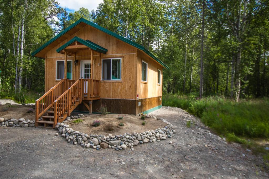 a small wooden cabin in the middle of a forest at Talkeetna Wilderness Lodge & Cabin Rentals in Sunshine