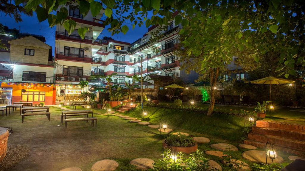 a courtyard of a hotel at night with benches and lights at Thamel Eco Resort in Kathmandu