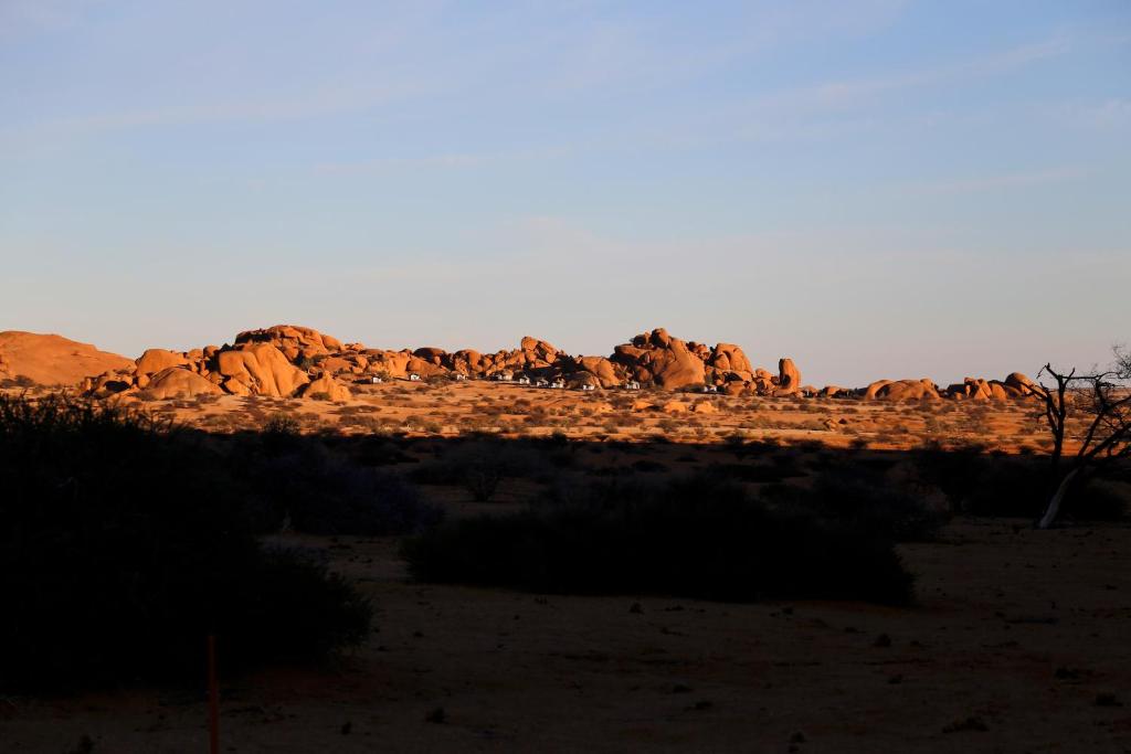 a group of rocks in the desert at sunset at Spitzkoppen Lodge in Usakos