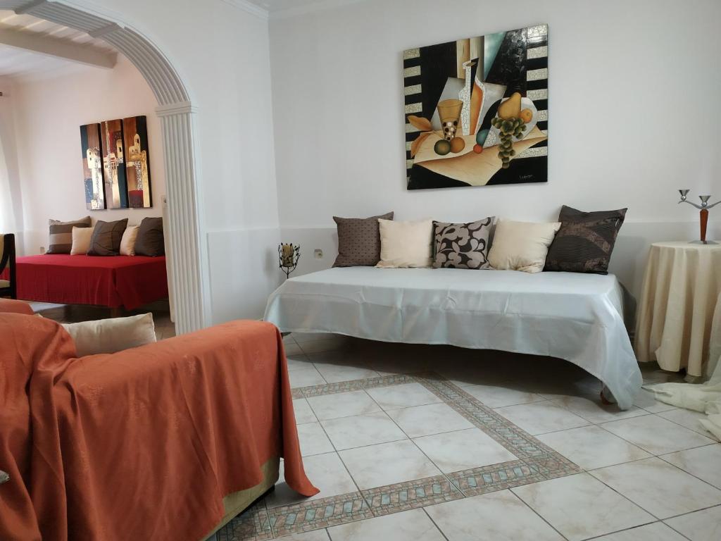 a living room with a bed and a couch at Apartment Gio III in Zakynthos Town