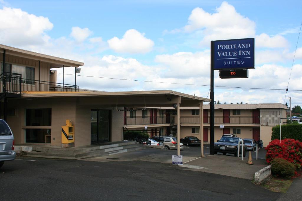 a sign in front of a building with a parking lot at Portland Value Inn & Suites in Portland