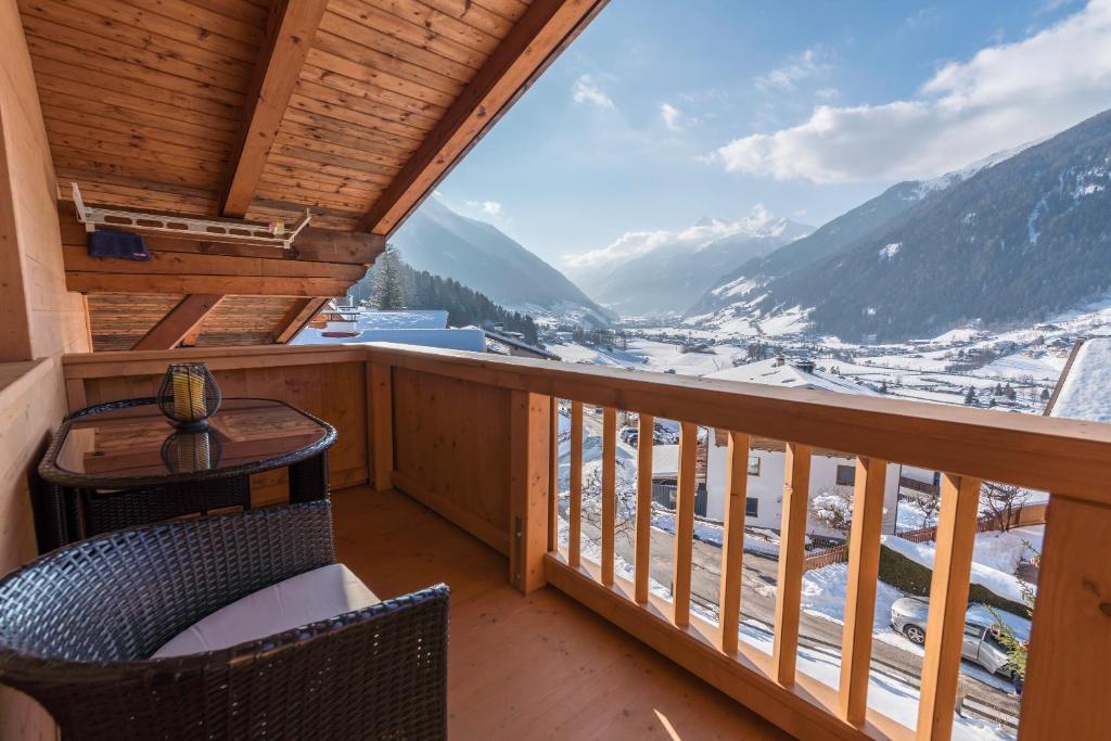 a balcony with a table and chairs and a view at Apartment Hildegard in Neustift im Stubaital