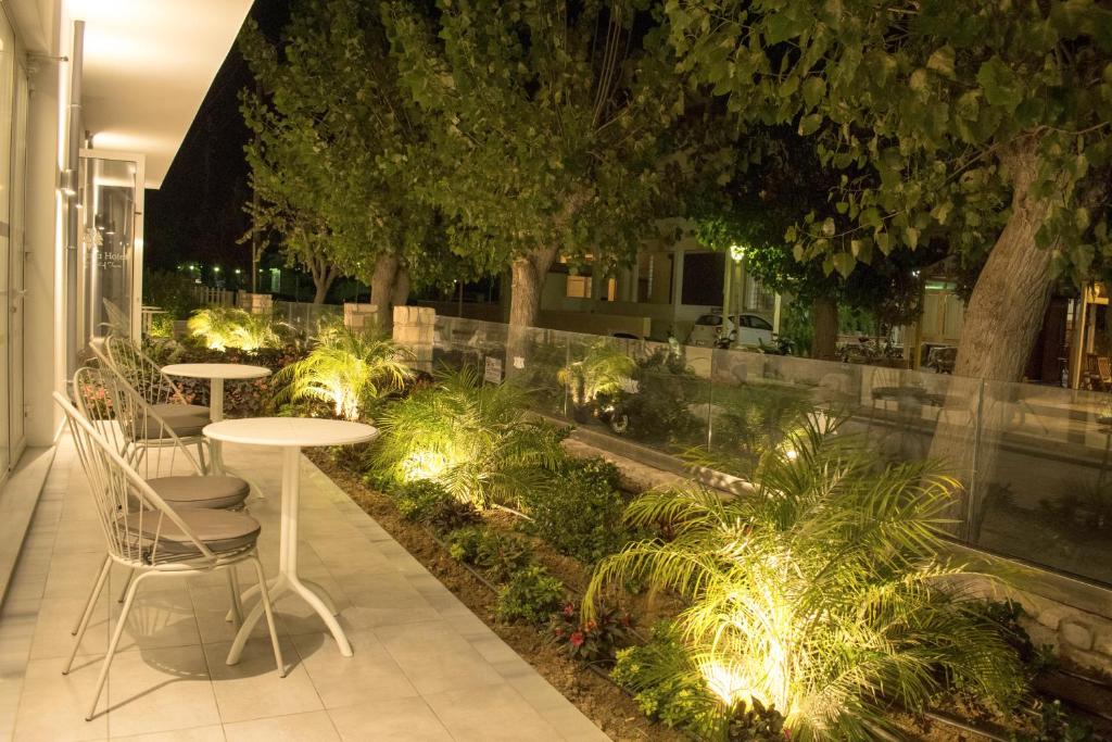 a patio with tables and chairs and lights at Anastasia Hotel & Apartments in Kos