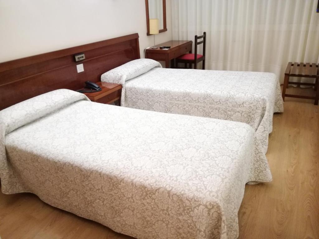 Postel nebo postele na pokoji v ubytování Hotel Almendra