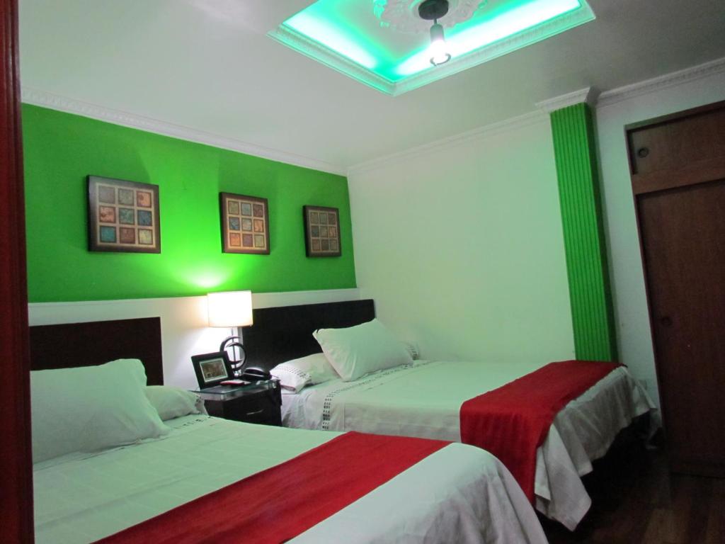 Postel nebo postele na pokoji v ubytování Hotel Apartasuite Normandia