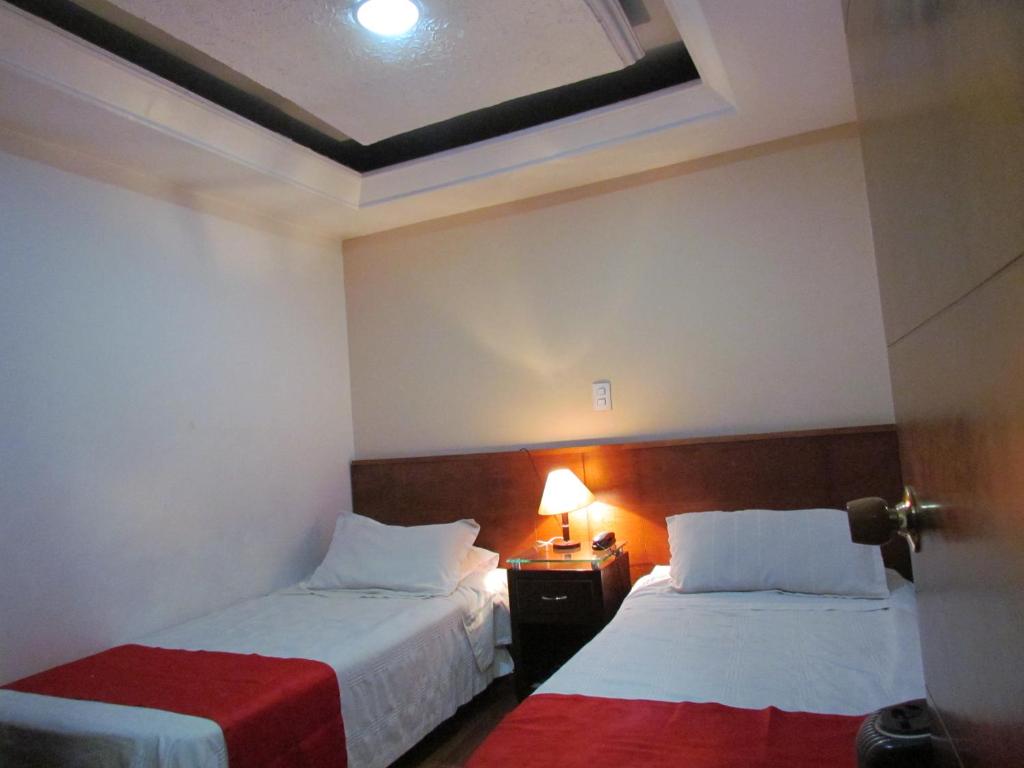 Postel nebo postele na pokoji v ubytování Hotel Apartasuite Normandia