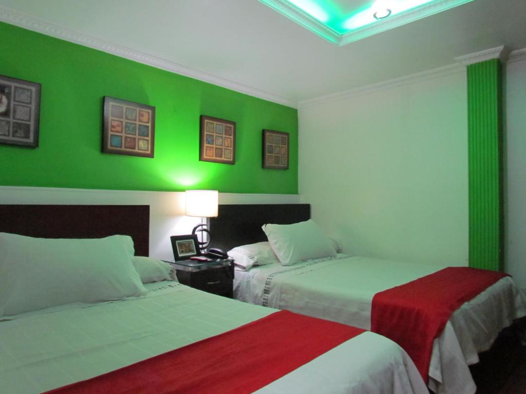 Postel nebo postele na pokoji v ubytování Hotel Apartasuite Normandia