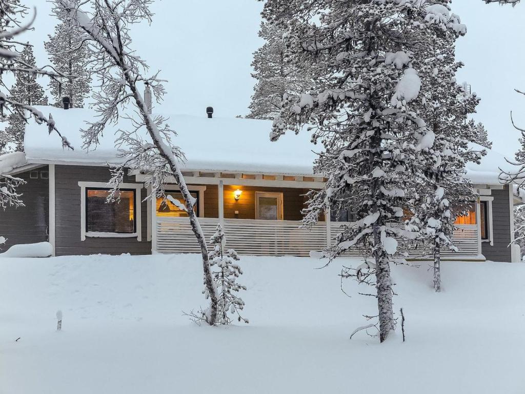 a house in the snow with snow covered trees at Holiday Home Hilla a by Interhome in Saariselka