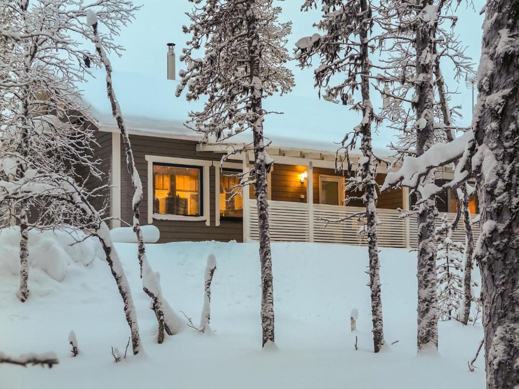 a cabin in the snow with snow covered trees at Holiday Home Hilla b by Interhome in Saariselka