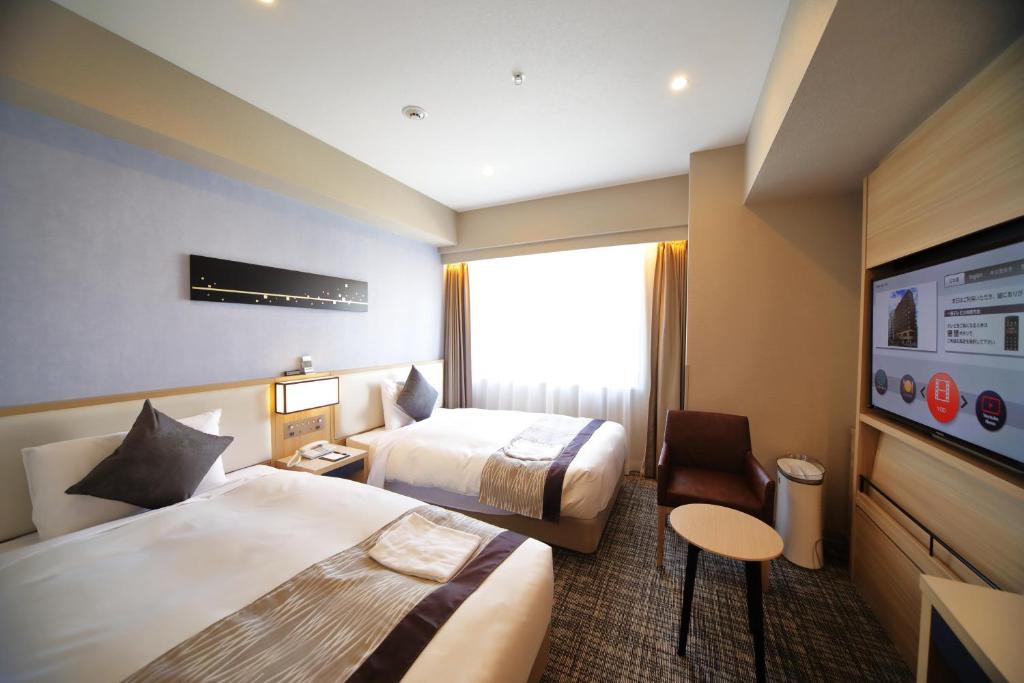 Postel nebo postele na pokoji v ubytování Hotel Sunroute Asakusa
