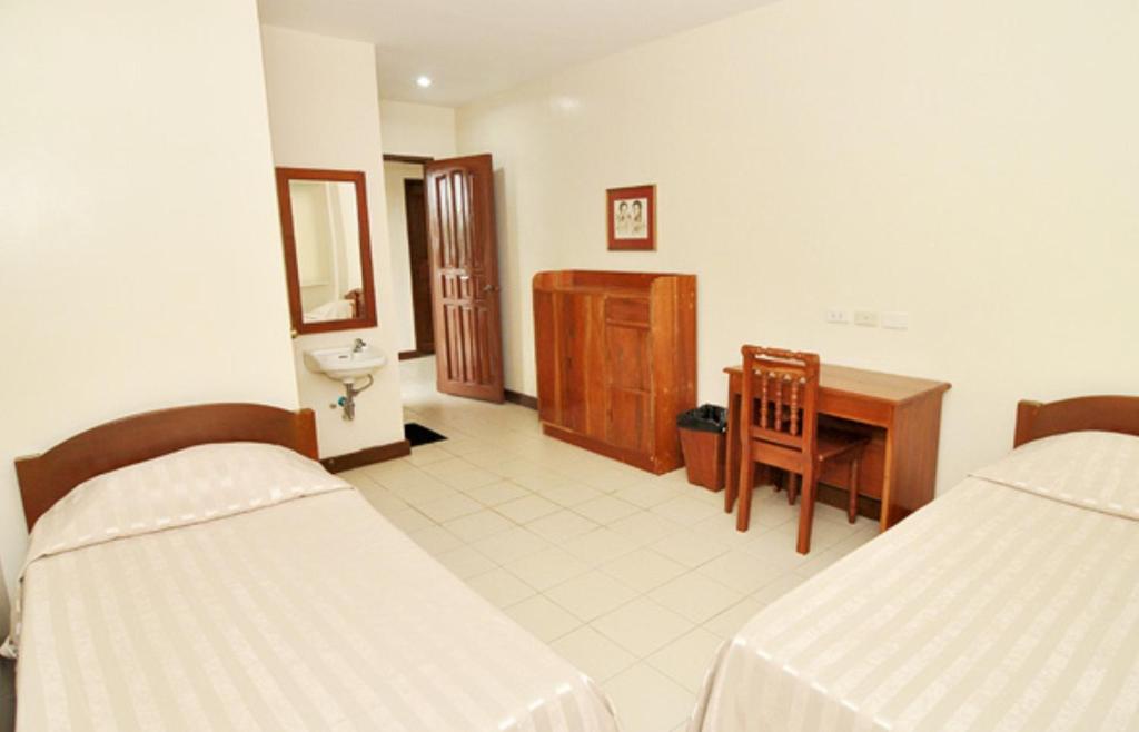 Postel nebo postele na pokoji v ubytování El Haciendero Private Hotel