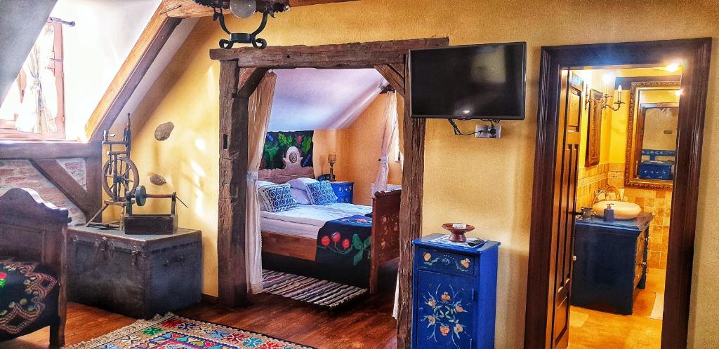 a bedroom with a bed and a flat screen tv at Casa Bertha in Sighişoara