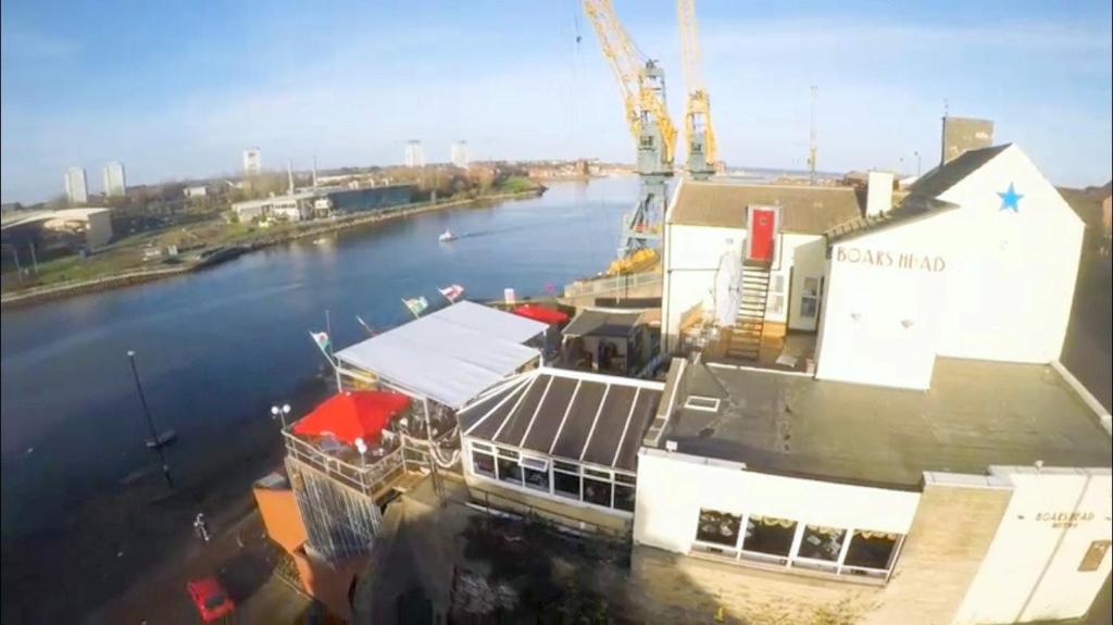 a view of a river with a building and a crane at Boars Head Boutique Hotel in Sunderland