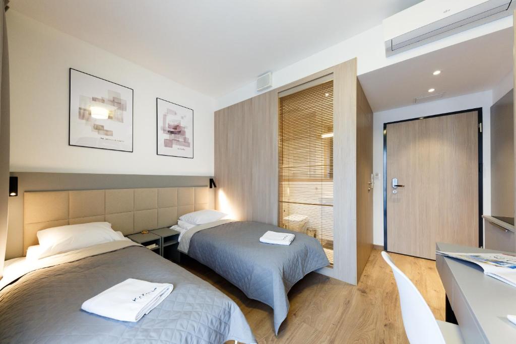 Posteľ alebo postele v izbe v ubytovaní Apartments "Wolska Residence"
