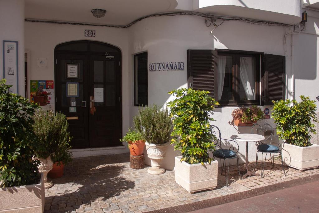 a group of potted plants sitting outside of a building at Guest House Dianamar in Albufeira