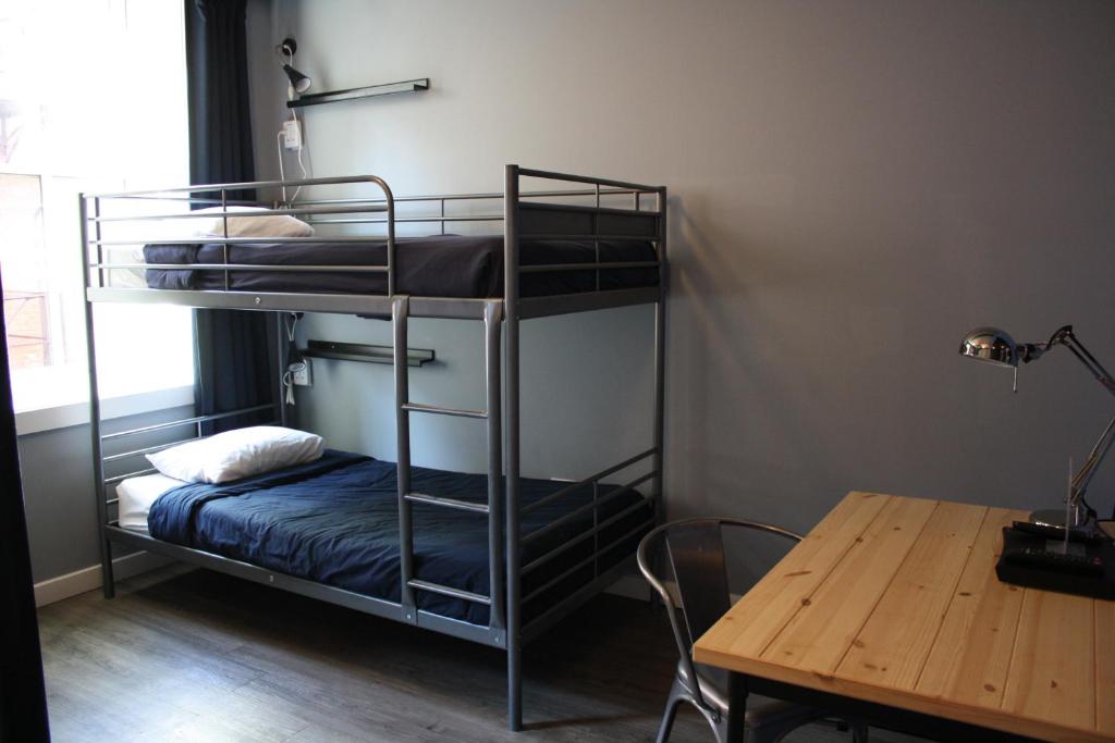 a room with two bunk beds and a table at Apple Hostels of Philadelphia in Philadelphia
