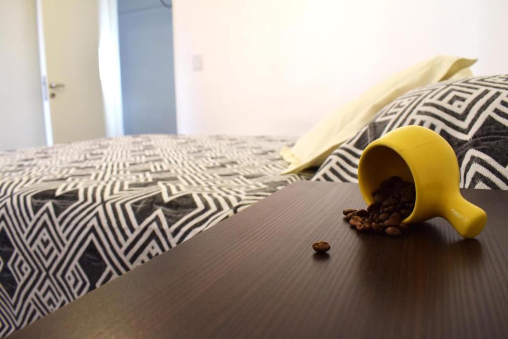 a yellow bird toy sitting on top of a bed at "Tu Lugar en el Norte" Dpto SADIMA - Barrio Norte in San Miguel de Tucumán