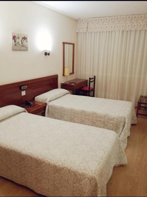 Postel nebo postele na pokoji v ubytování Hotel Almendra