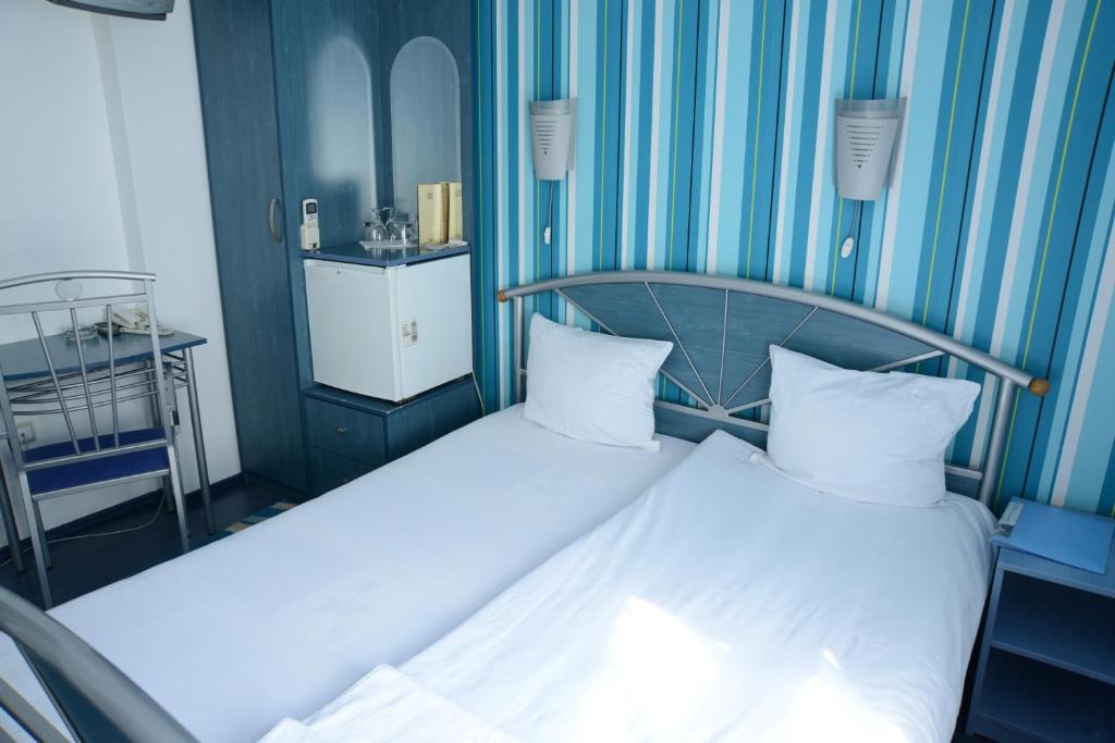 Postel nebo postele na pokoji v ubytování Hotel Ženeva