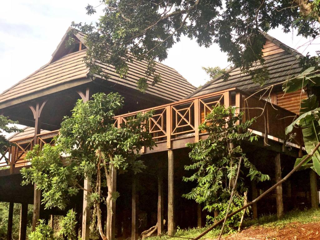 a large wooden house with a gambrel roof at House 23 Ezulwini in Sodwana Bay Lodge in Sodwana Bay