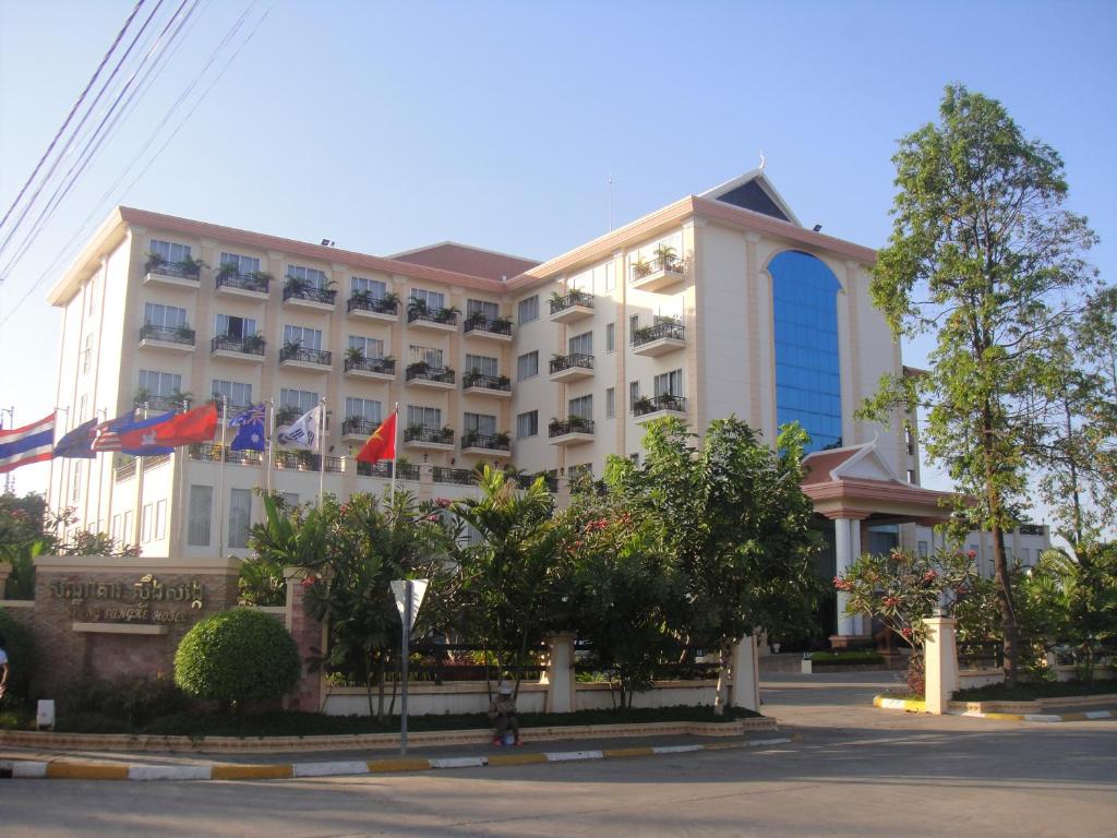 a hotel building with flags in front of it at Stung Sangke Hotel in Battambang