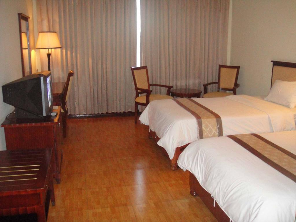 Postel nebo postele na pokoji v ubytování Stung Sangke Hotel
