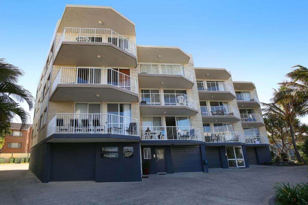 a tall apartment building with balconies and palm trees at Edmund Shores U5 58 Edmund Street in Caloundra