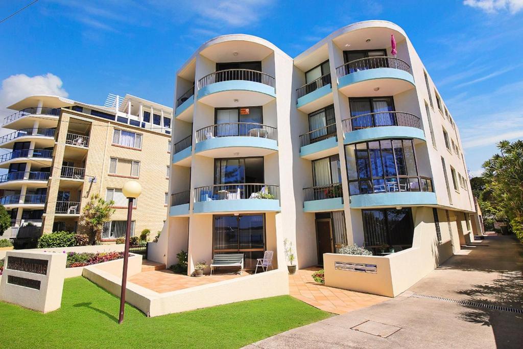a tall building with balconies on the side of it at Eastbourne U4 80 Esplanade Golden Beach in Caloundra