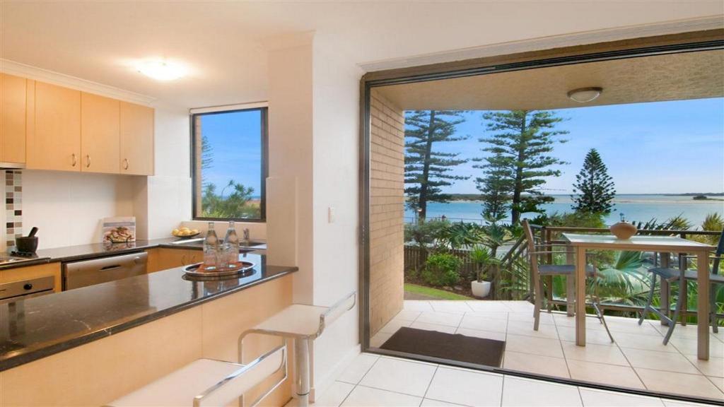 a kitchen with a view of the ocean at Allamanda U2 Awesome Location in Caloundra
