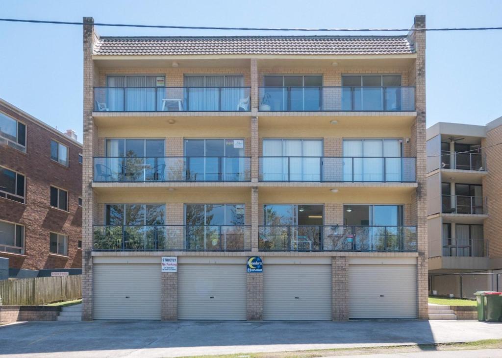 an apartment building with two garage doors at Moondara Unit 2 21 Bulcock Beach Esplanade Bulcock Beach in Caloundra