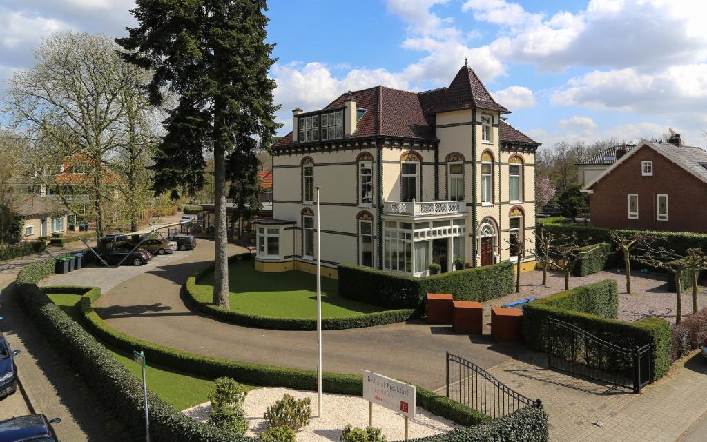 a large house with a turret on a street at Bed and Breakfast Terre Neuve in Velp