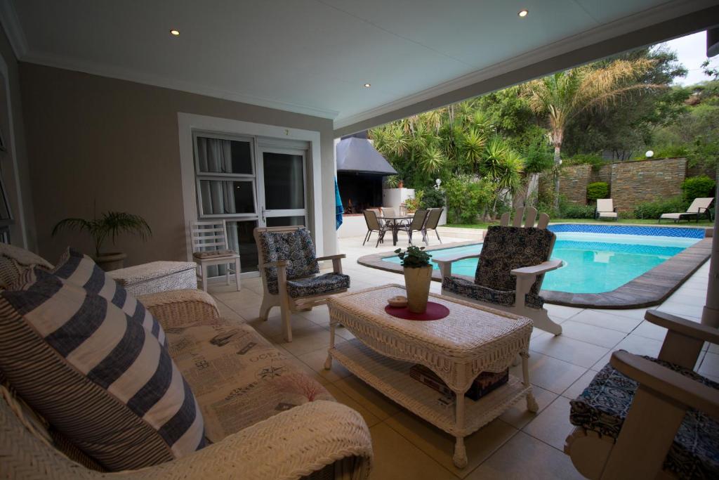 a patio with chairs and a swimming pool at House on Olof Palme in Windhoek