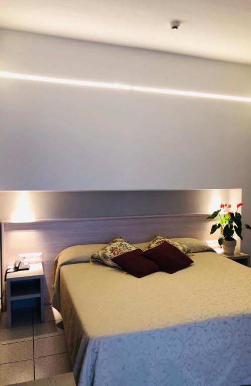 Postel nebo postele na pokoji v ubytování Hotel Delfina