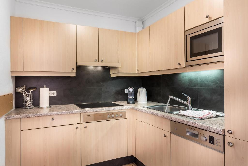 Kuchyň nebo kuchyňský kout v ubytování ALMHOF Alpin Apartments & Spa