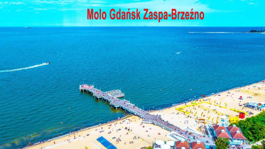 an aerial view of a beach with a pier at Apartament, Kwatera Prywatna - SŁONECZNA PLAŻA dwupokojowe balkon wifi 20 min spacerkiem od plaży in Gdańsk