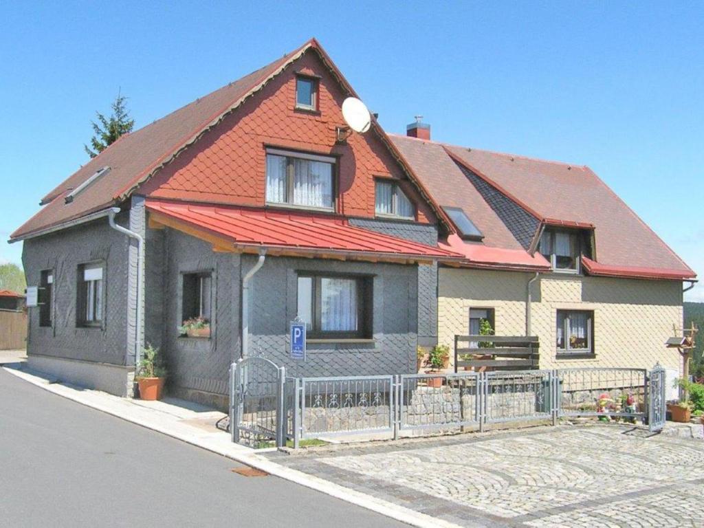 a house with a fence in front of it at Flat near the forest in Frauenwald Thuringia in Frauenwald