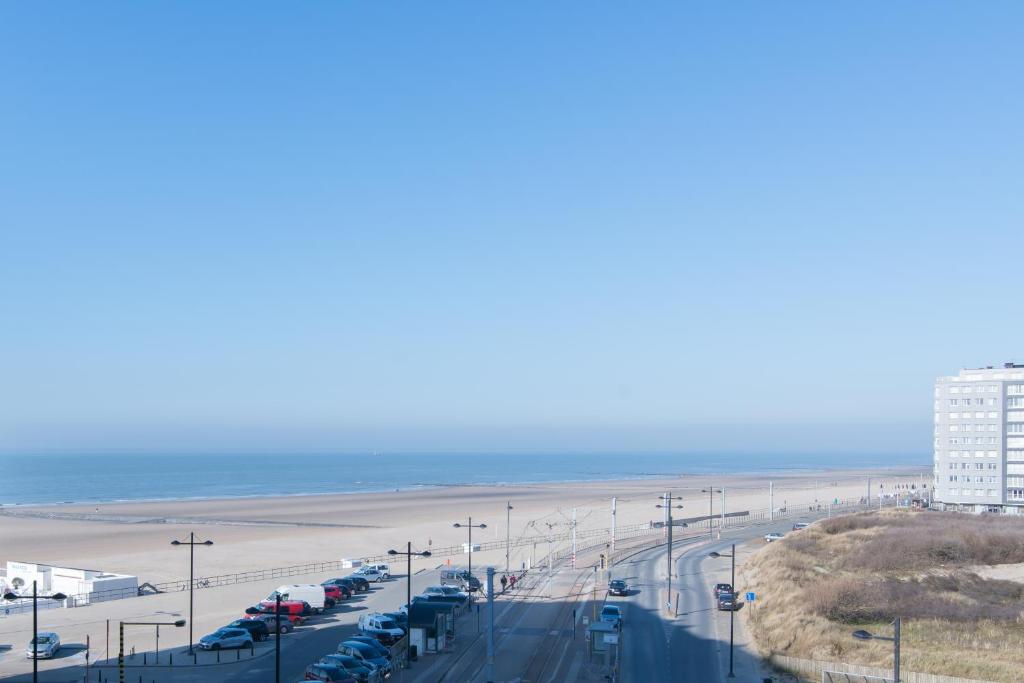 a highway with cars parked next to a beach at Lumina Suite in Middelkerke