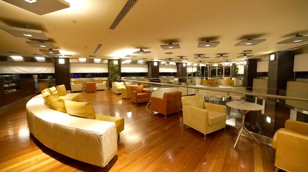 a lobby with couches and chairs and a bar at Point Hotel Taksim in Istanbul