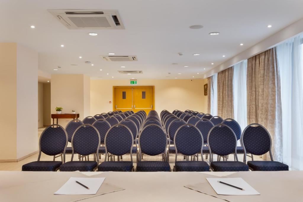 a conference room with rows of chairs and a table at Plaza Regency Hotels in Sliema