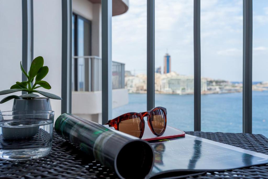 a pair of glasses sitting on top of a table at Plaza Regency Hotels in Sliema